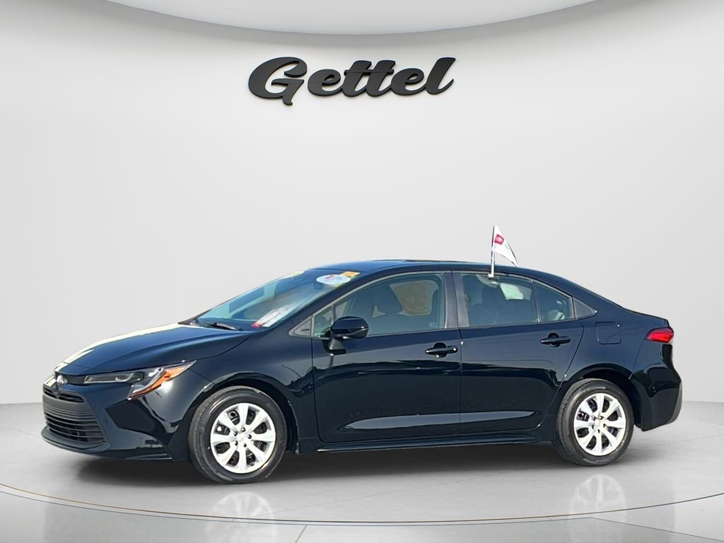 2024 Toyota Corolla LE in Midnight Black Metal — front three-quarter view
